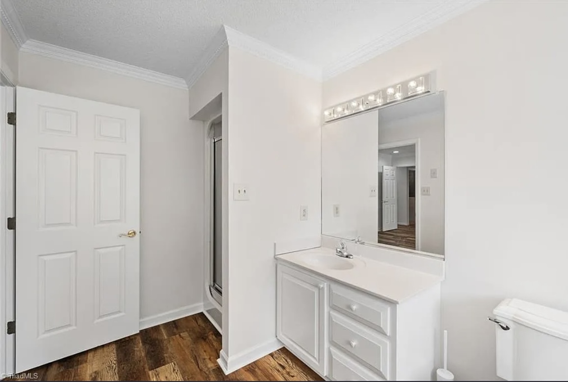 Repainted bathroom with crisp white trim and vanity